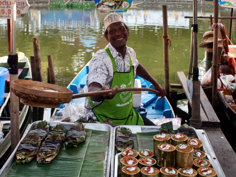 a man selling food on a boat in the water