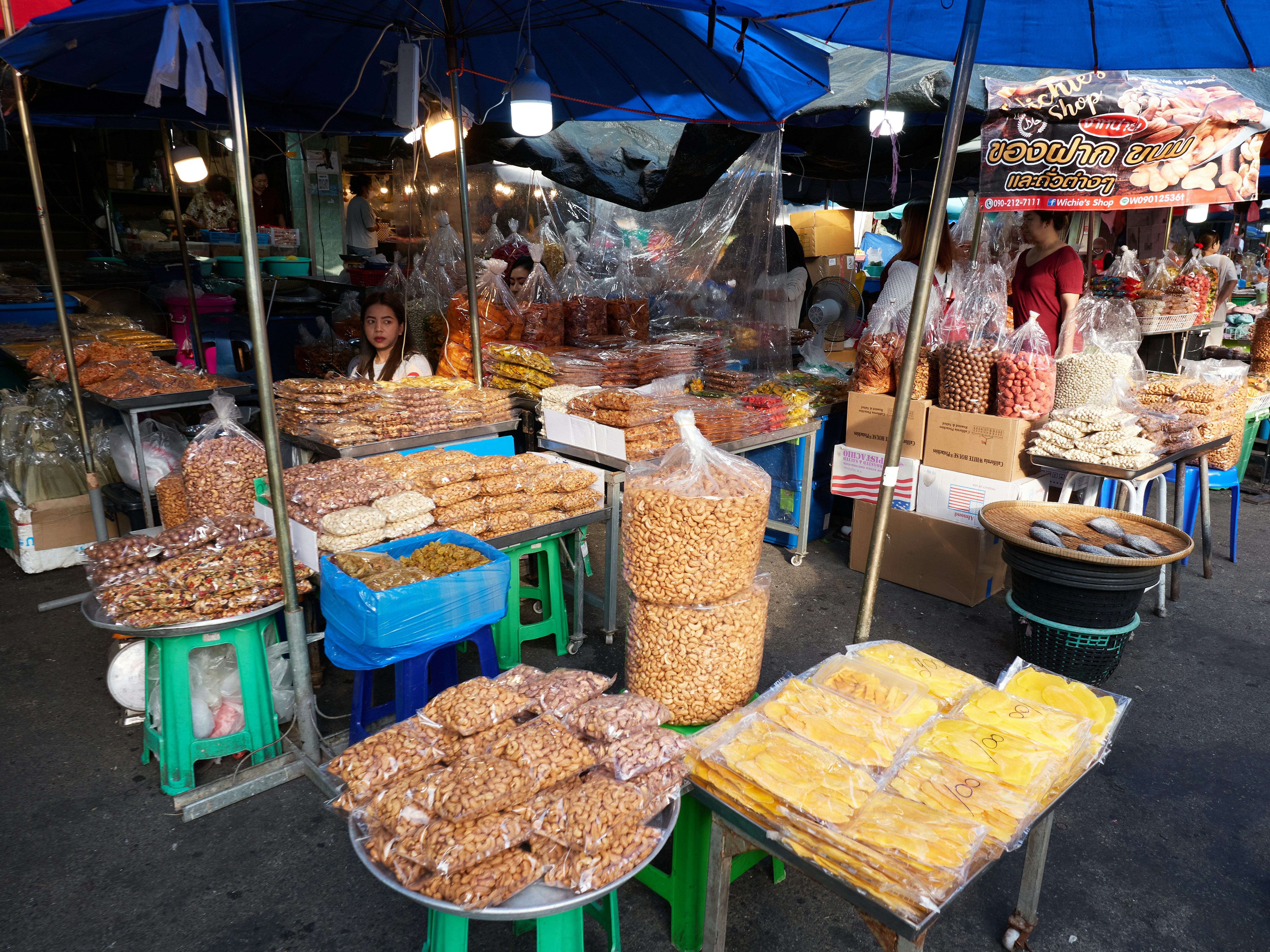 a bunch of food that is under a blue umbrella, 