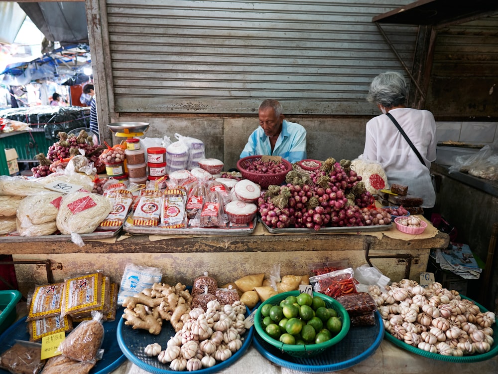 a man sitting at a table filled with lots of food