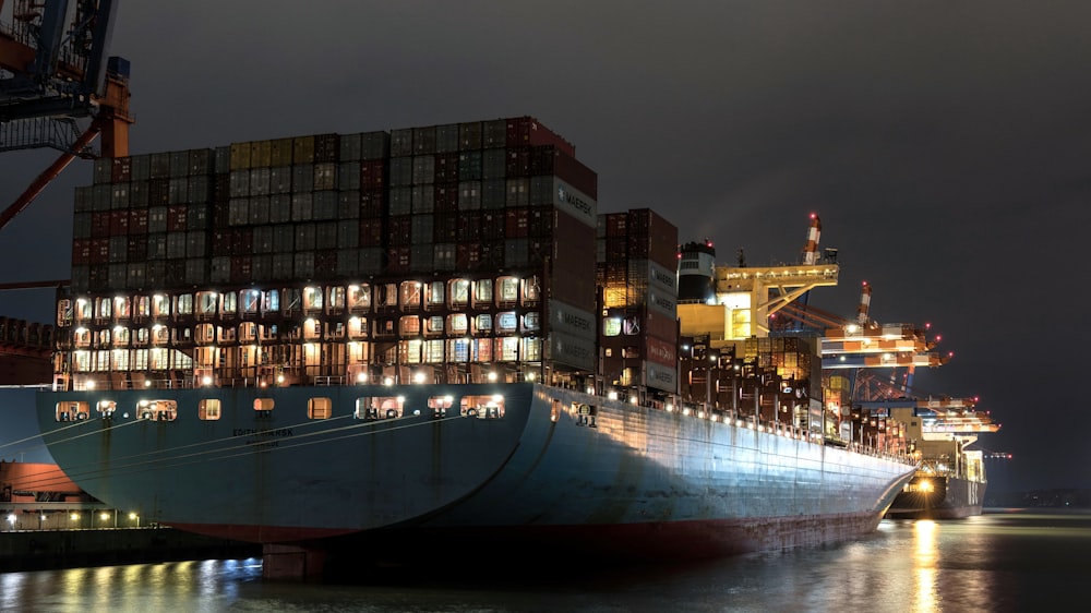 a large cargo ship in a harbor at night