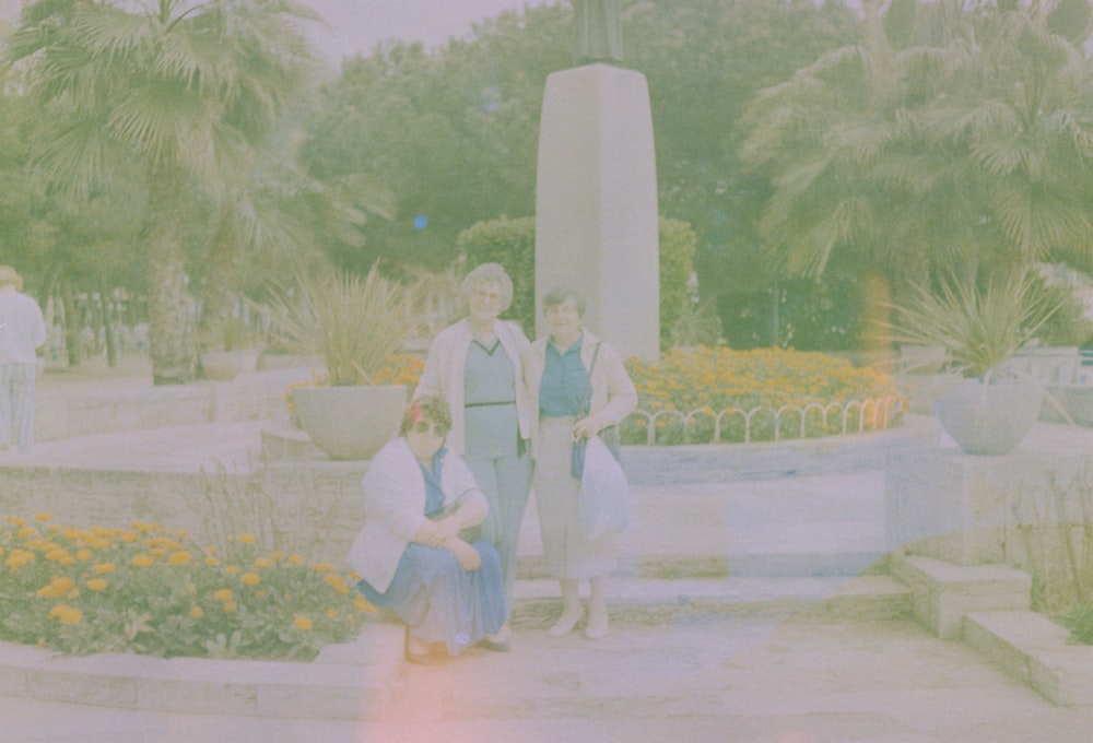 a group of women standing next to each other in a park