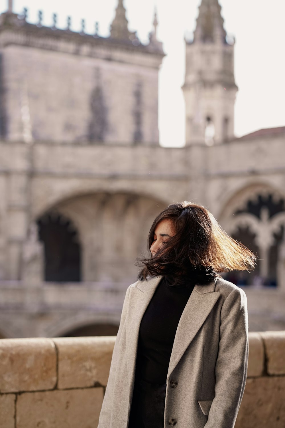 a woman standing in front of a large building