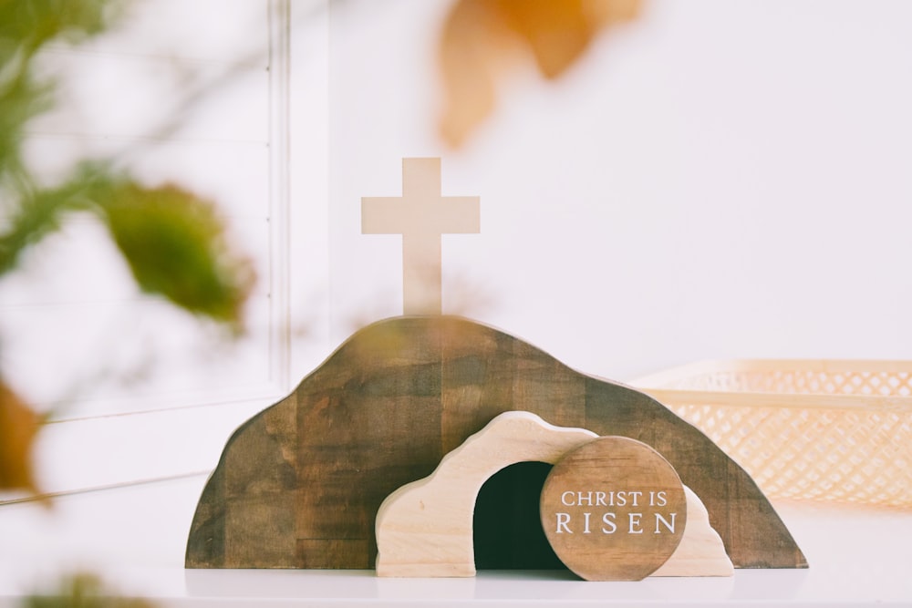 a wooden cross sitting on top of a table