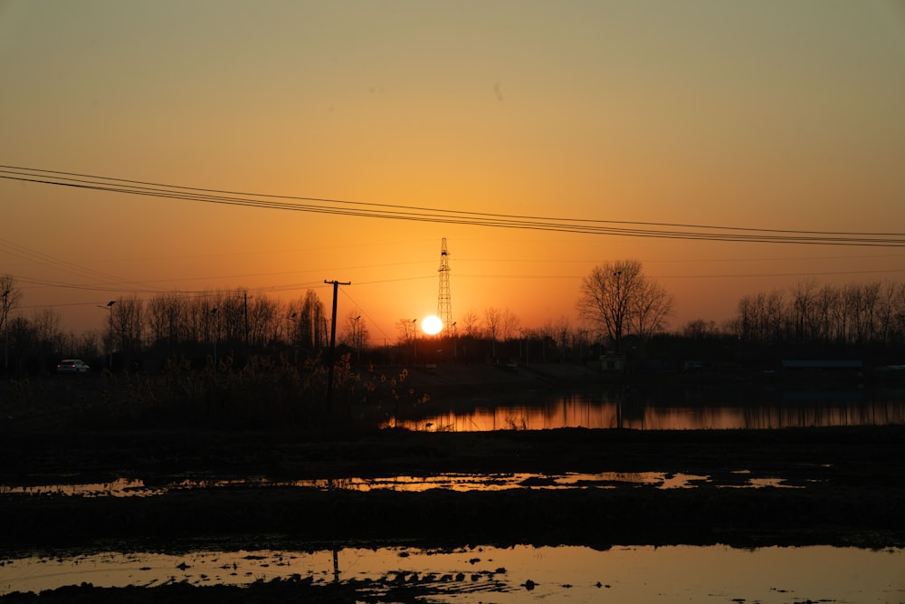 the sun is setting over a body of water