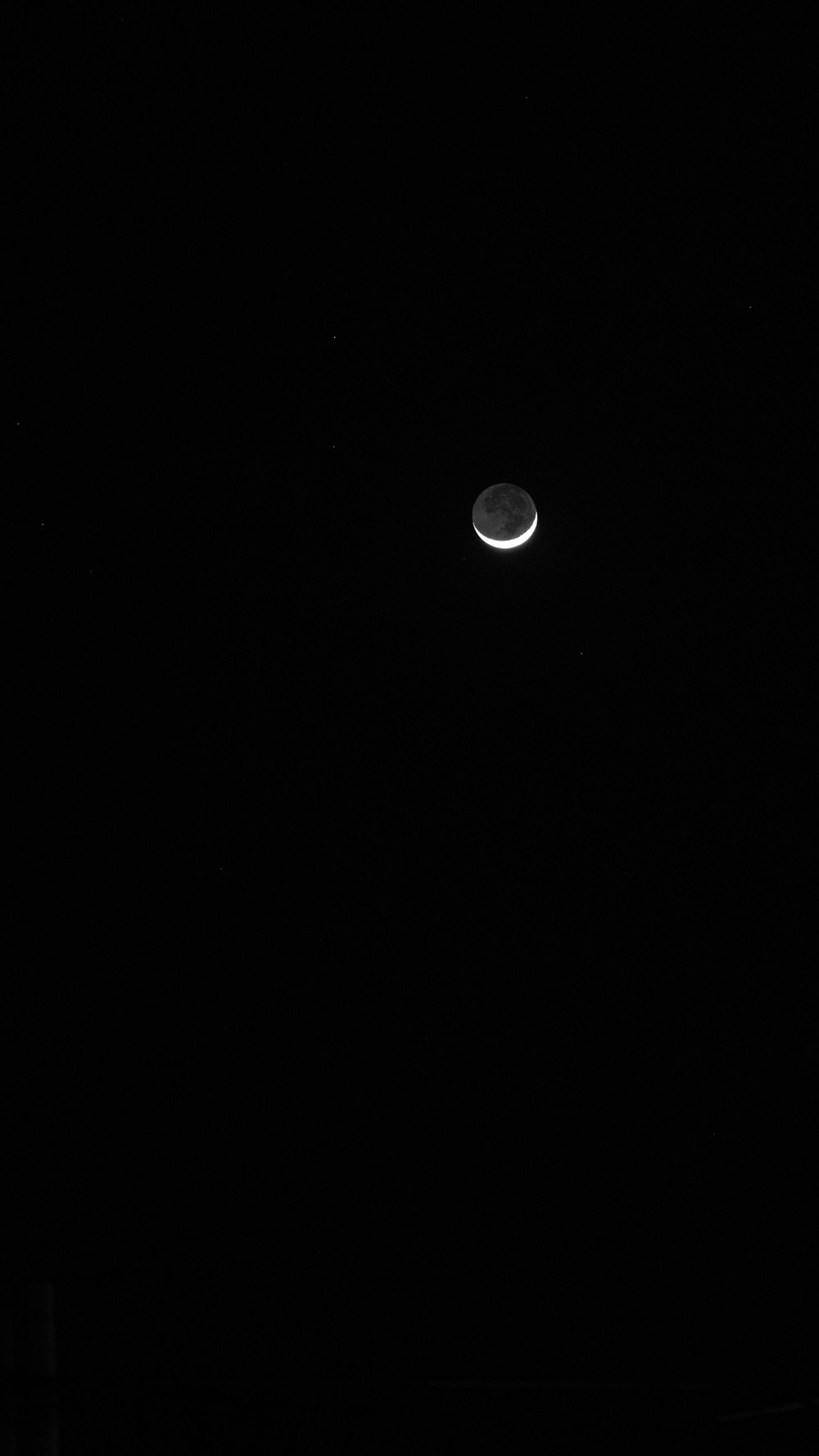 the moon is visible in the dark night sky