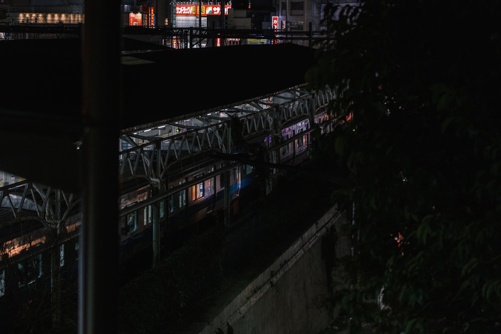 a train traveling through a train station at night