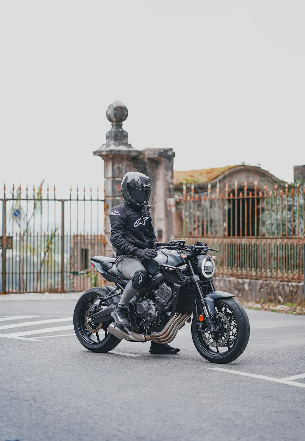 a man riding a motorcycle down a street