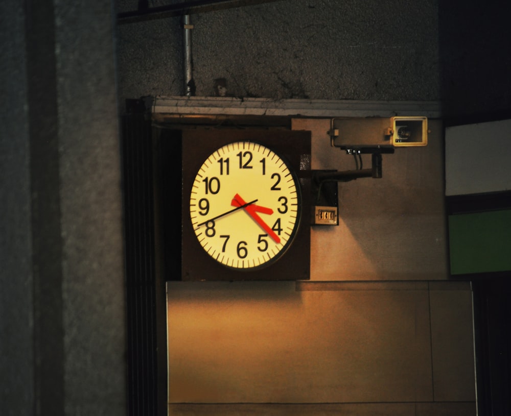 a clock hanging from the side of a building