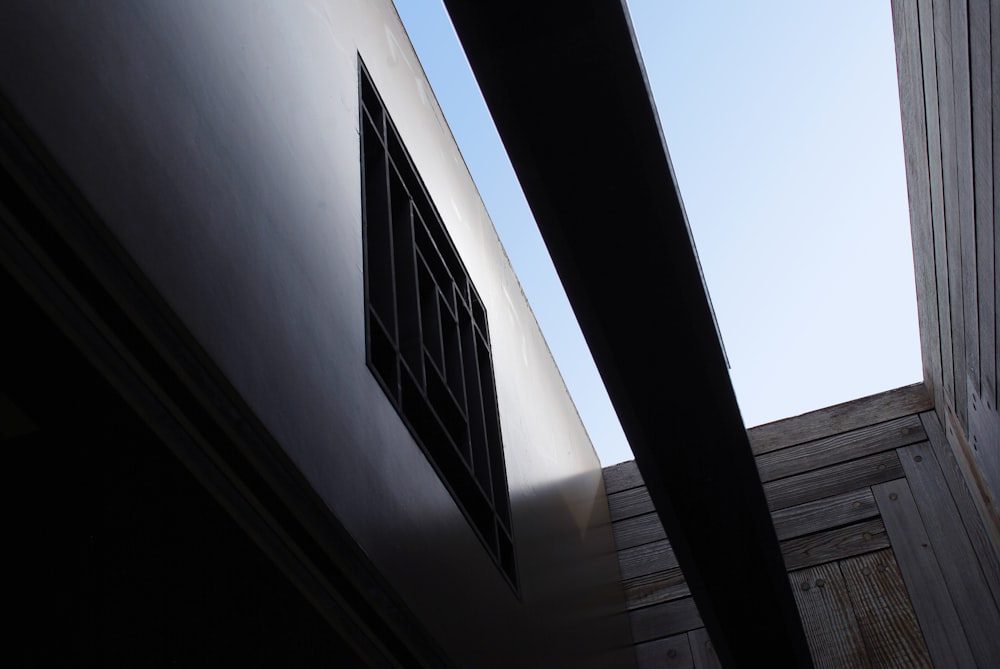 a building with a window and a sky in the background