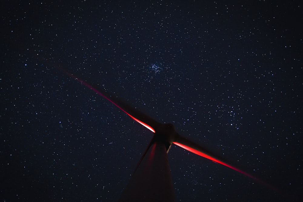 a wind mill with a star filled sky in the background