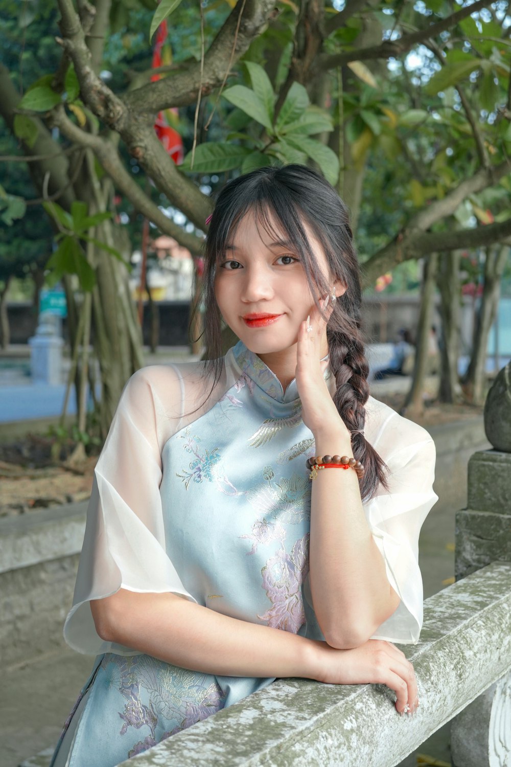 a woman with a braid sitting on a bench