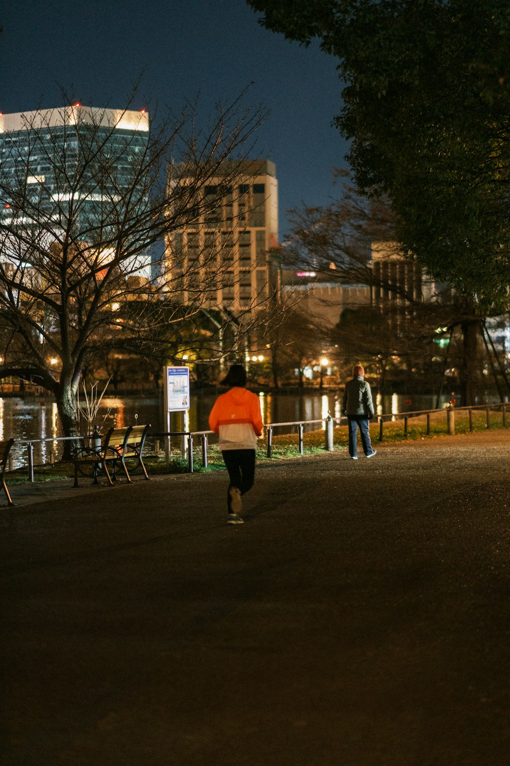 a person walking down a street at night