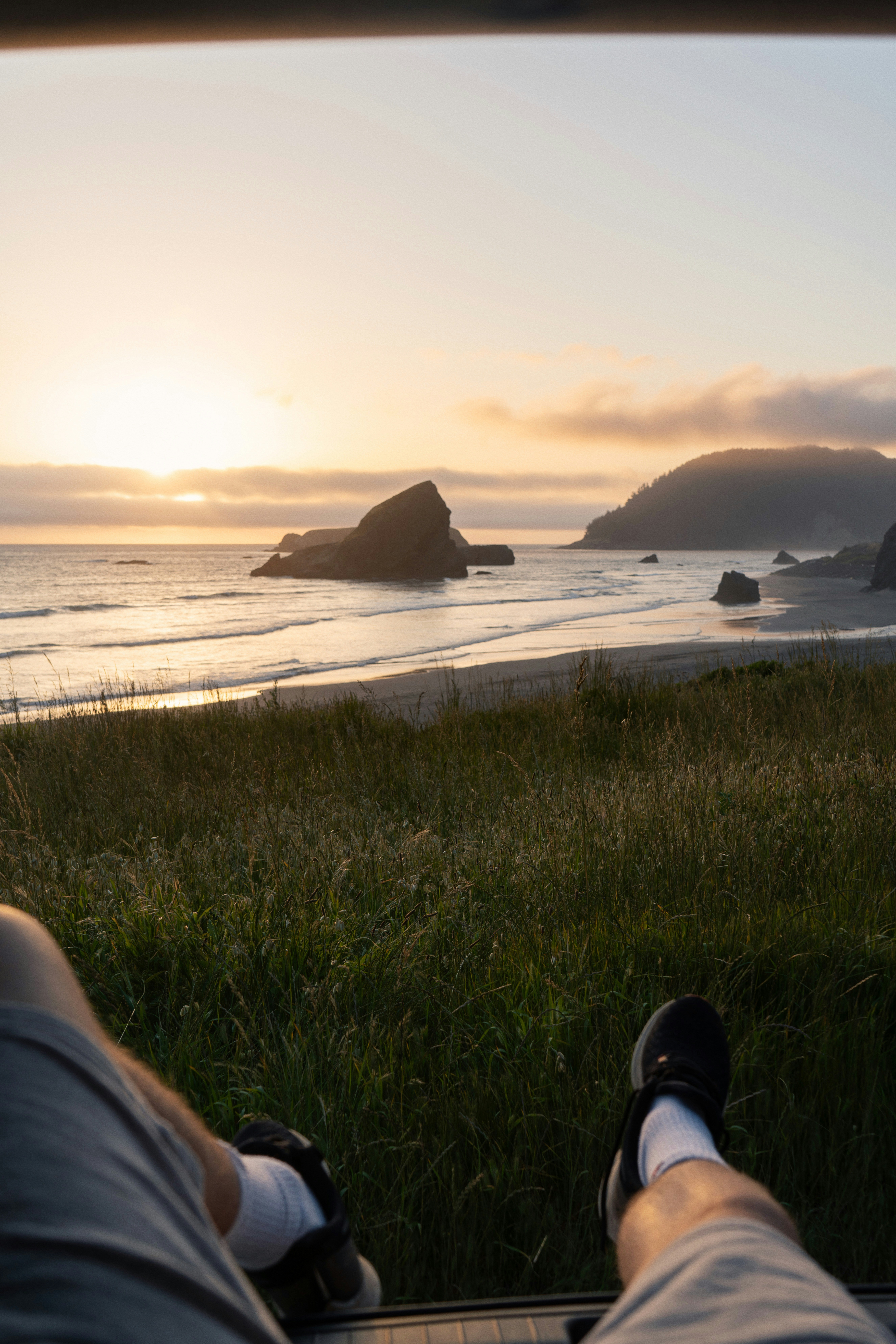 a person sitting in a chair looking out at the ocean