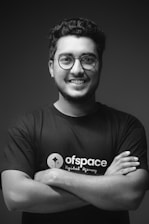 a man with glasses is posing for a picture