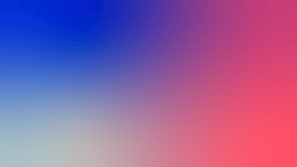 a blurry image of a red, blue, and pink background