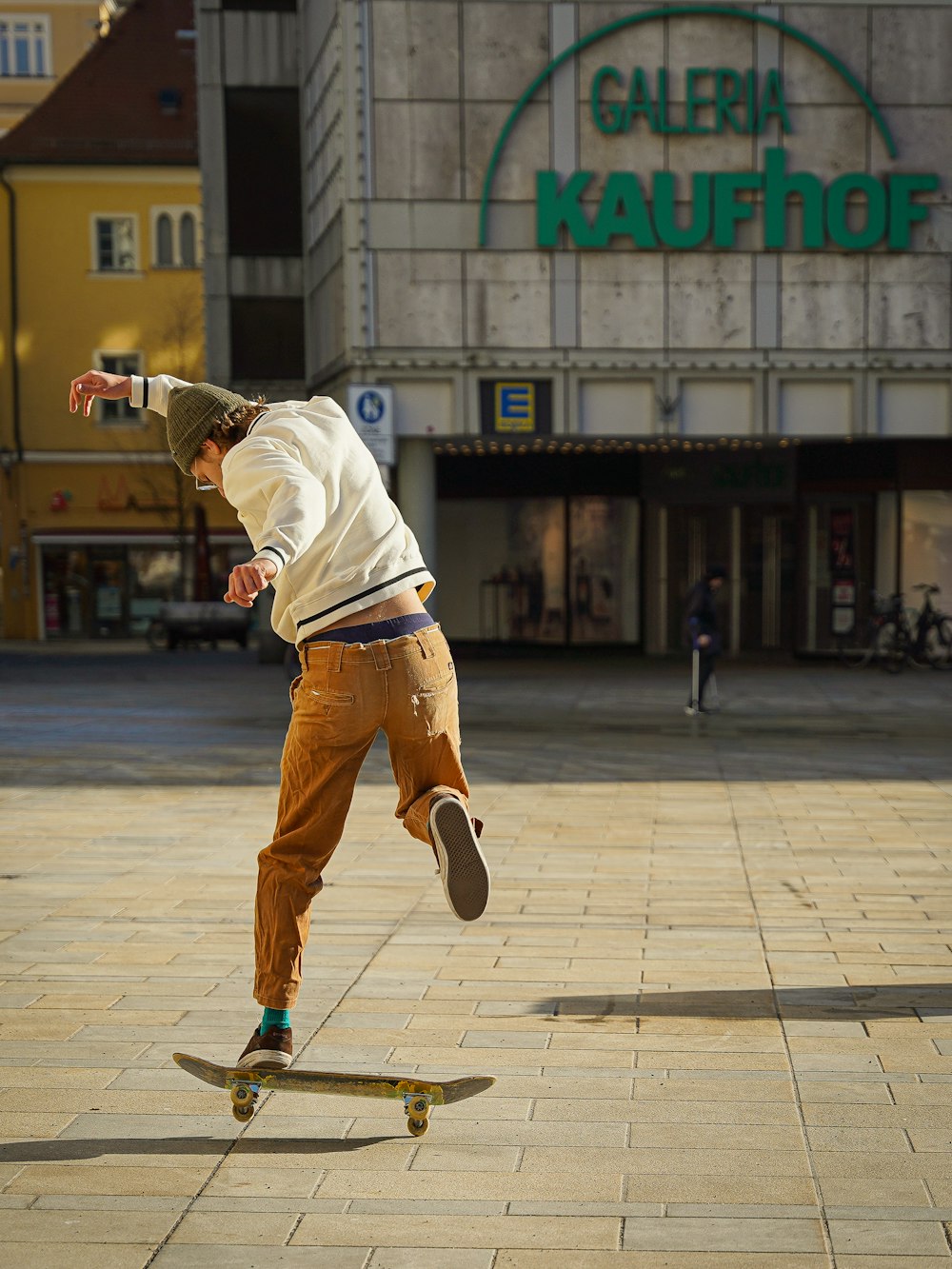 a man riding a skateboard down a sidewalk