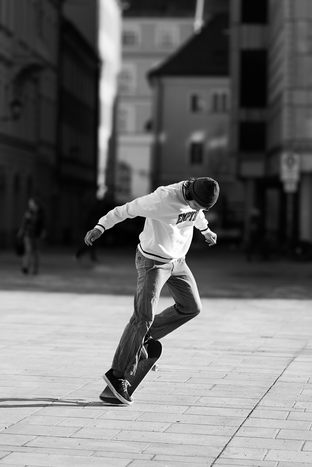 a man riding a skateboard down a sidewalk