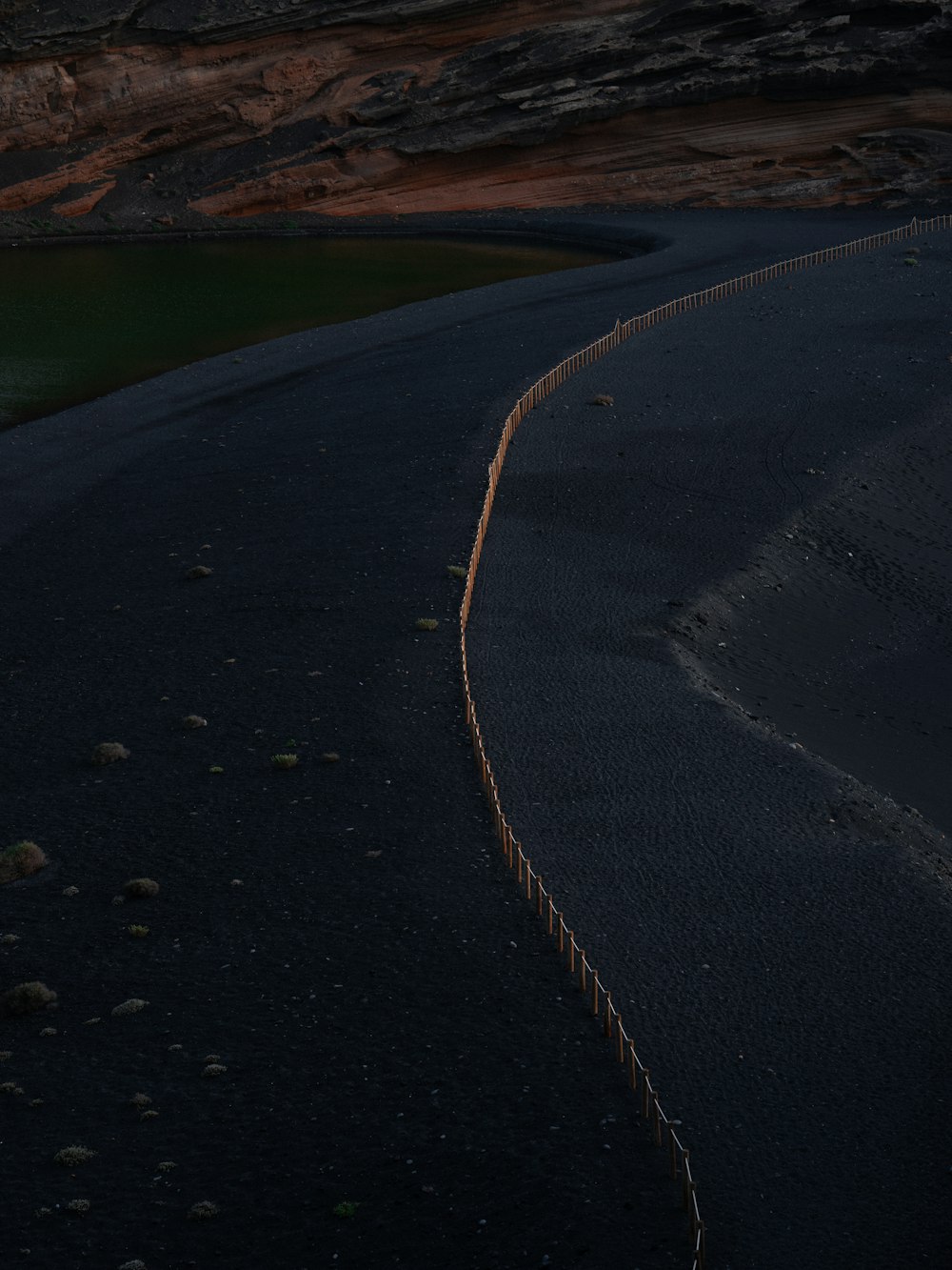 a road that has a fence on the side of it