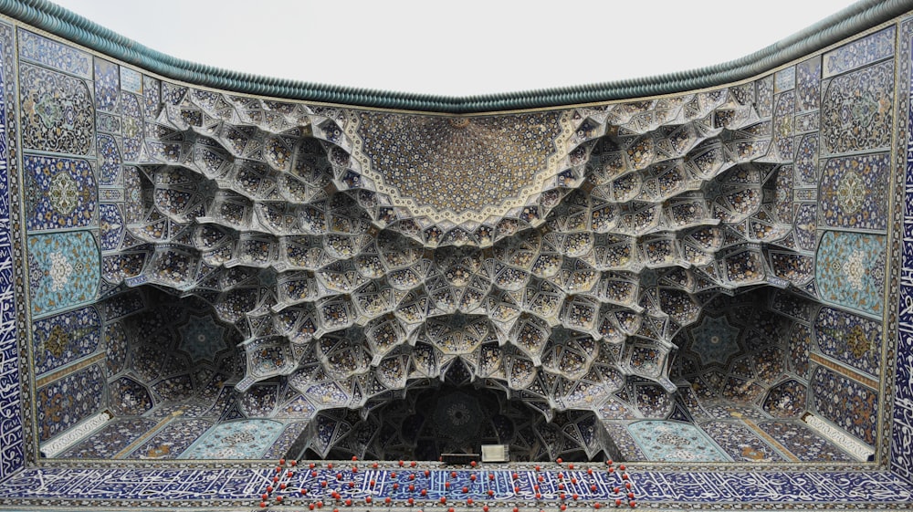 an intricately designed room with blue and white tiles