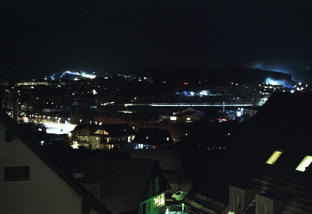 a view of a city at night from a rooftop