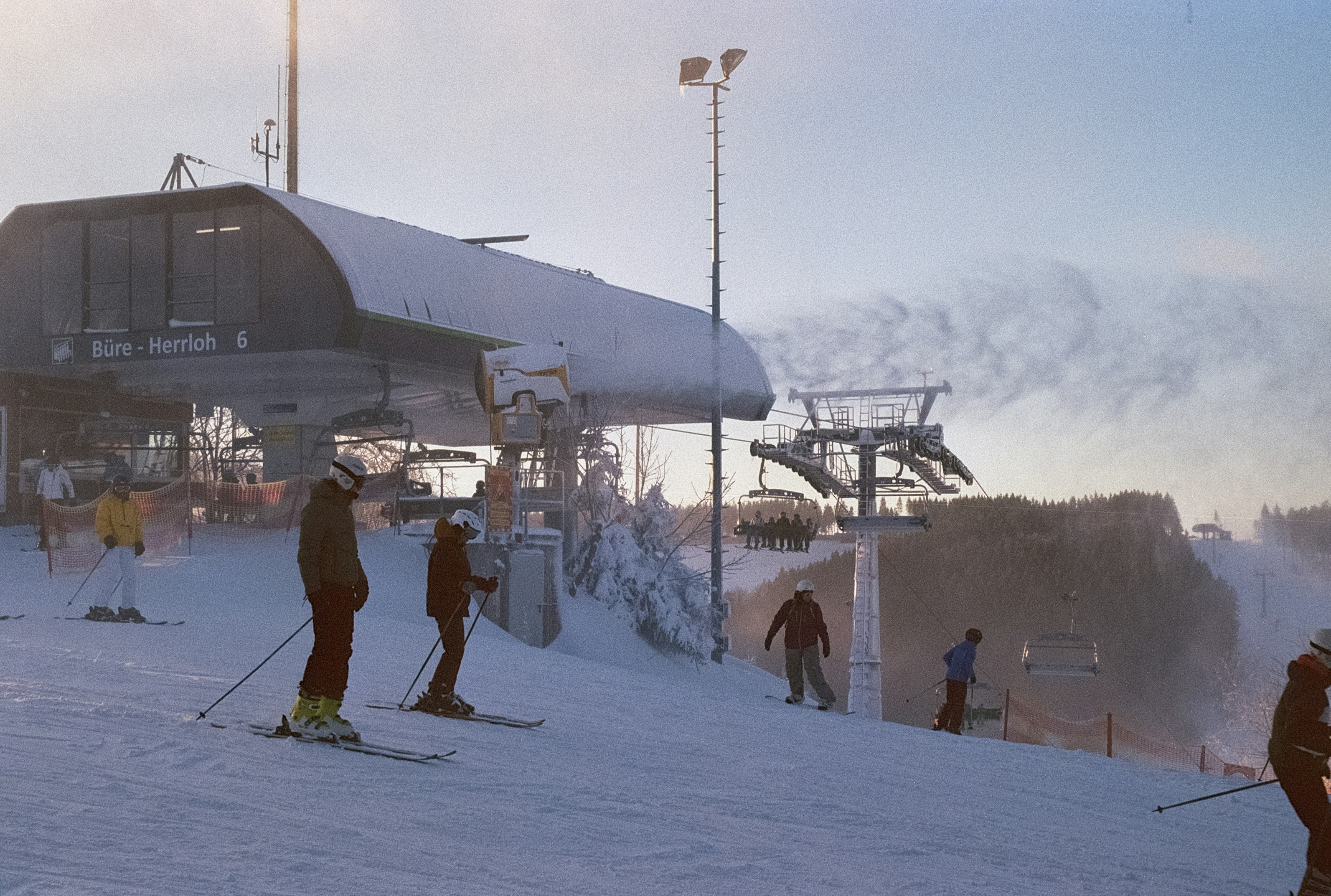 a group of people riding skis on top of a snow covered slope, 
