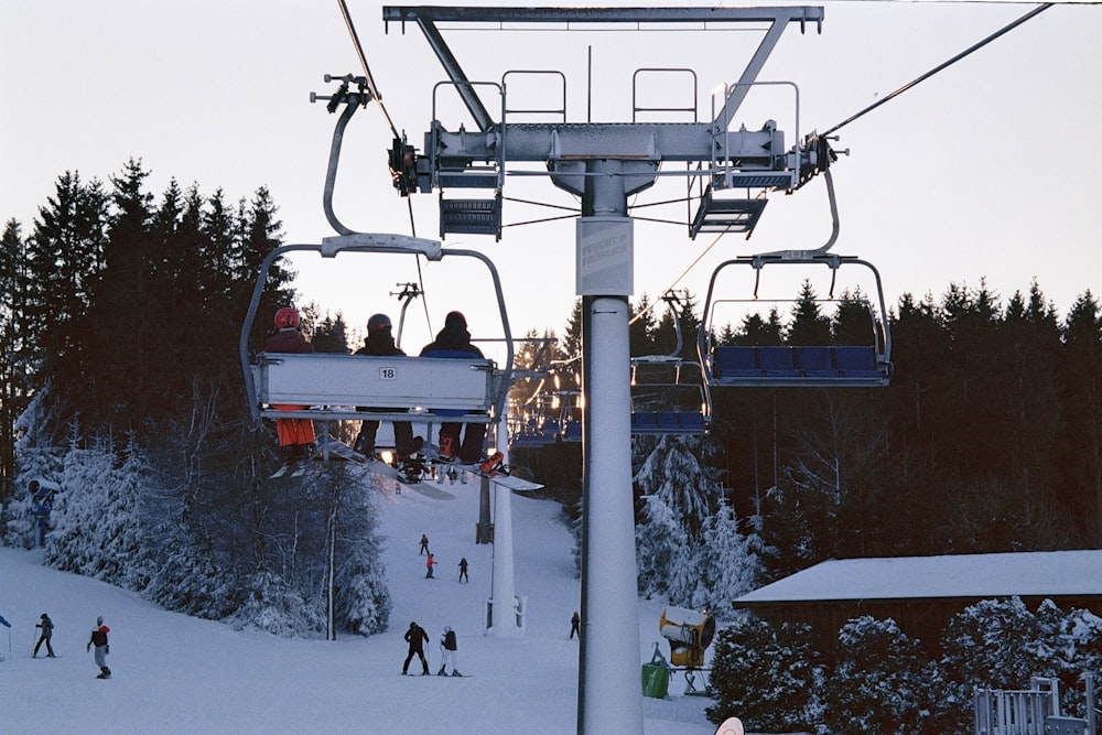 a ski lift with people skiing down it