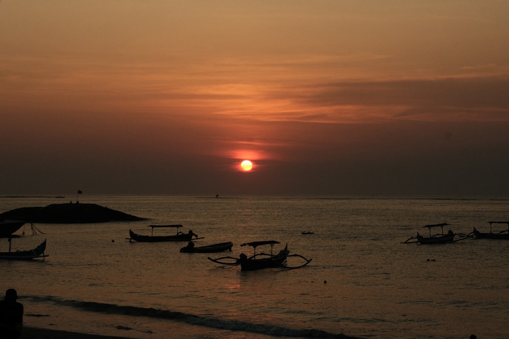 a group of boats floating on top of a body of water