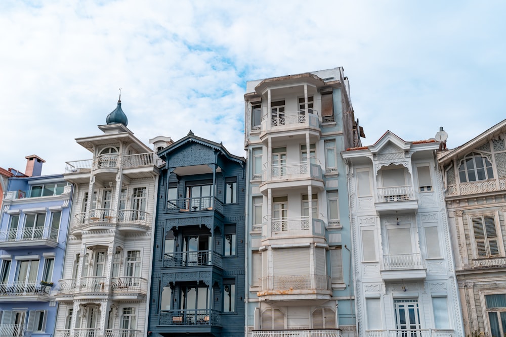 a row of multicolored buildings with a blue sky in the background