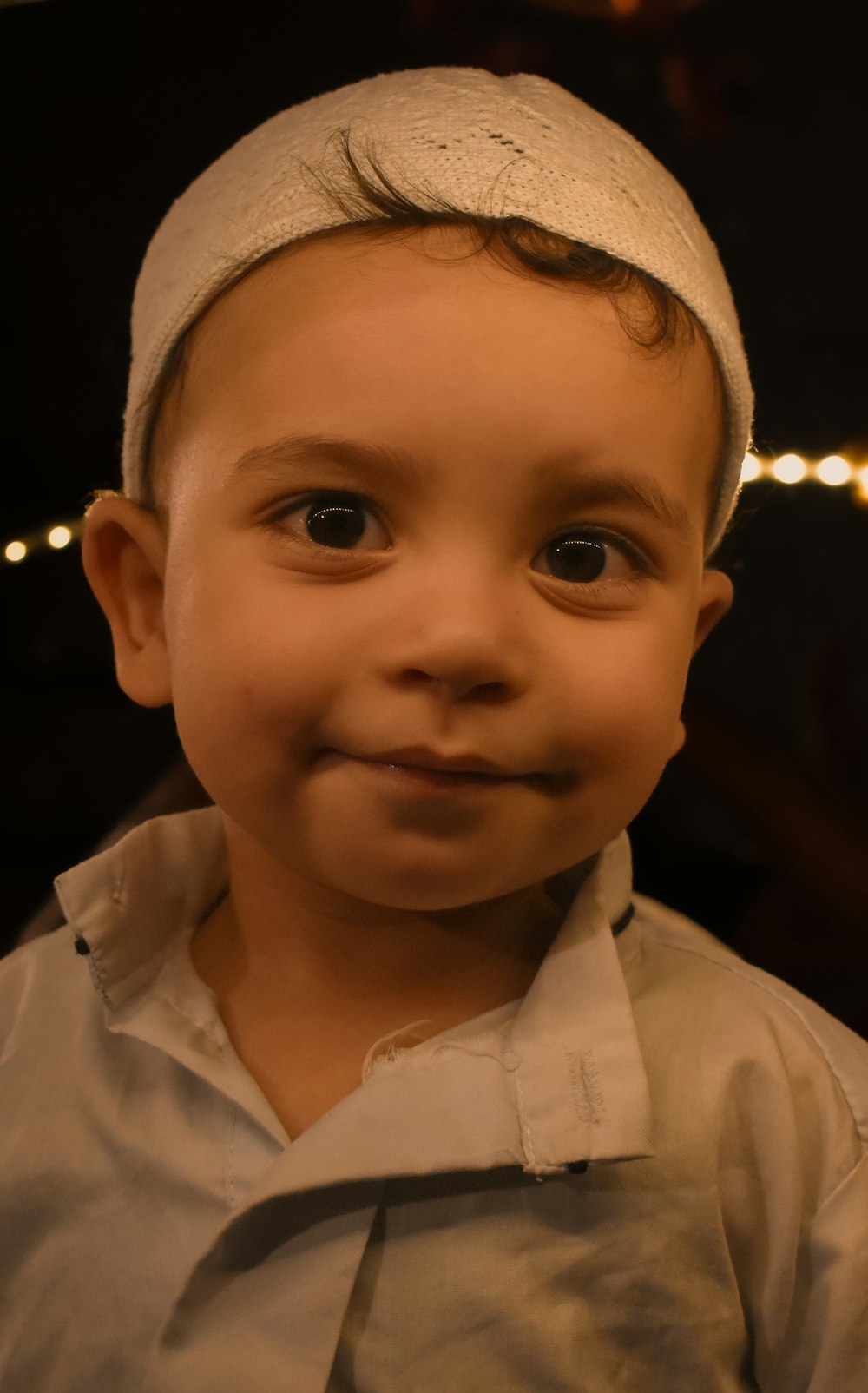 a close up of a child wearing a hat