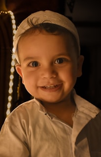 a little boy that is smiling for the camera