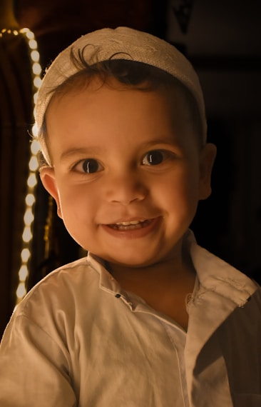 a little boy that is smiling for the camera