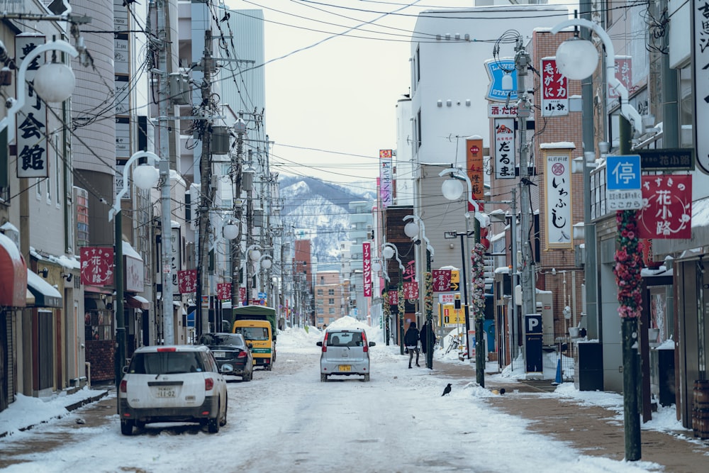 a car driving down a snow covered street