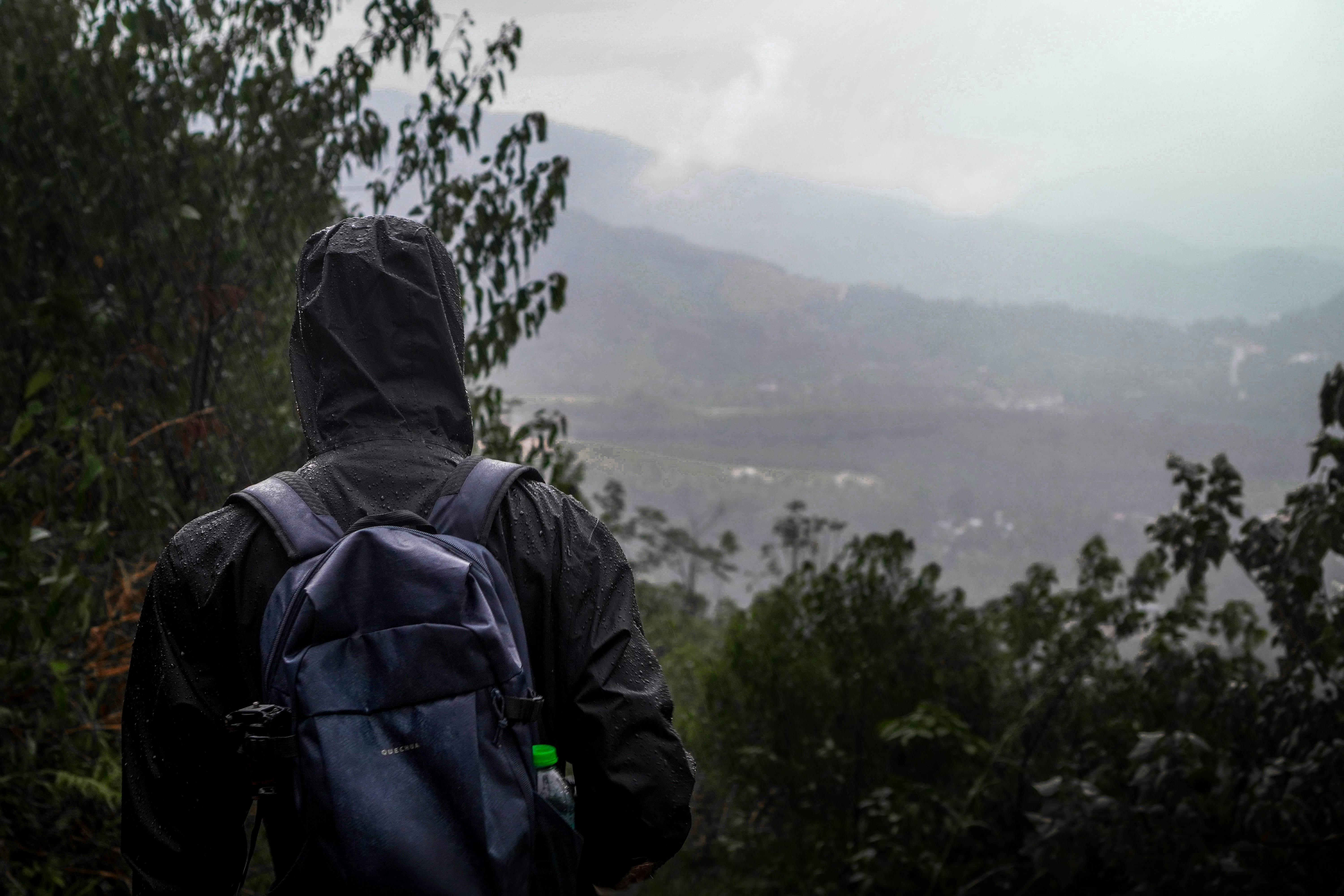 a person with a backpack walking up a hill