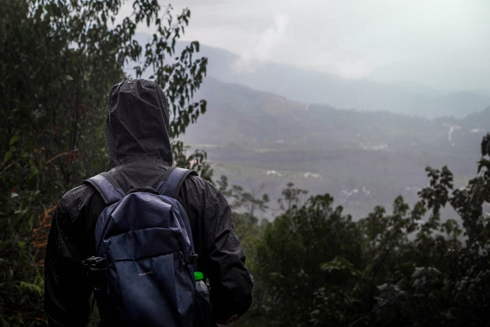 a person with a backpack walking up a hill