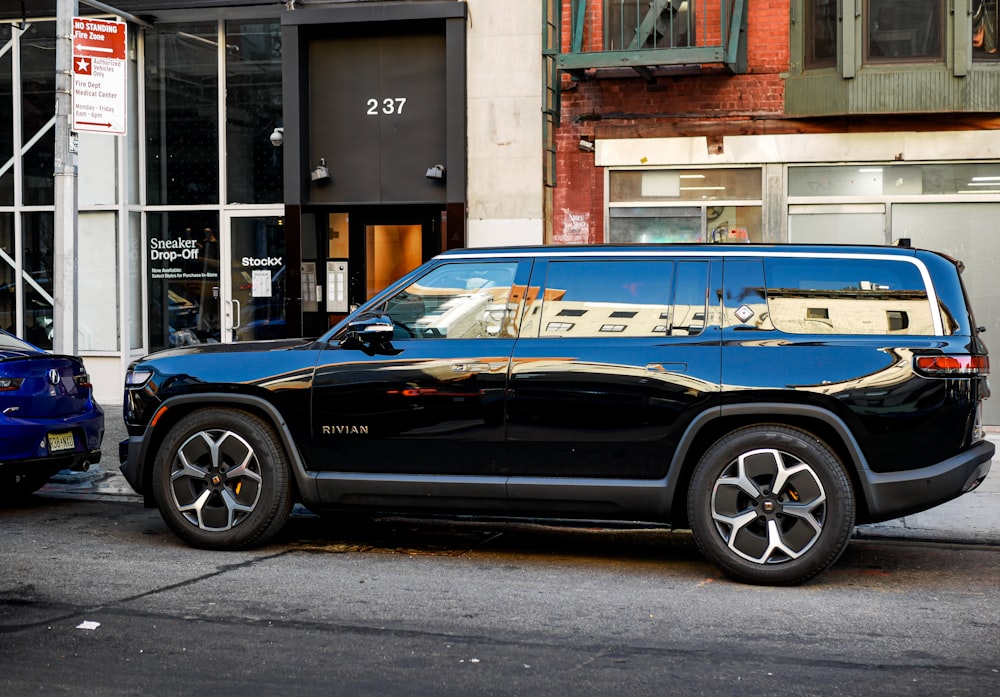 a black suv parked on the side of the road