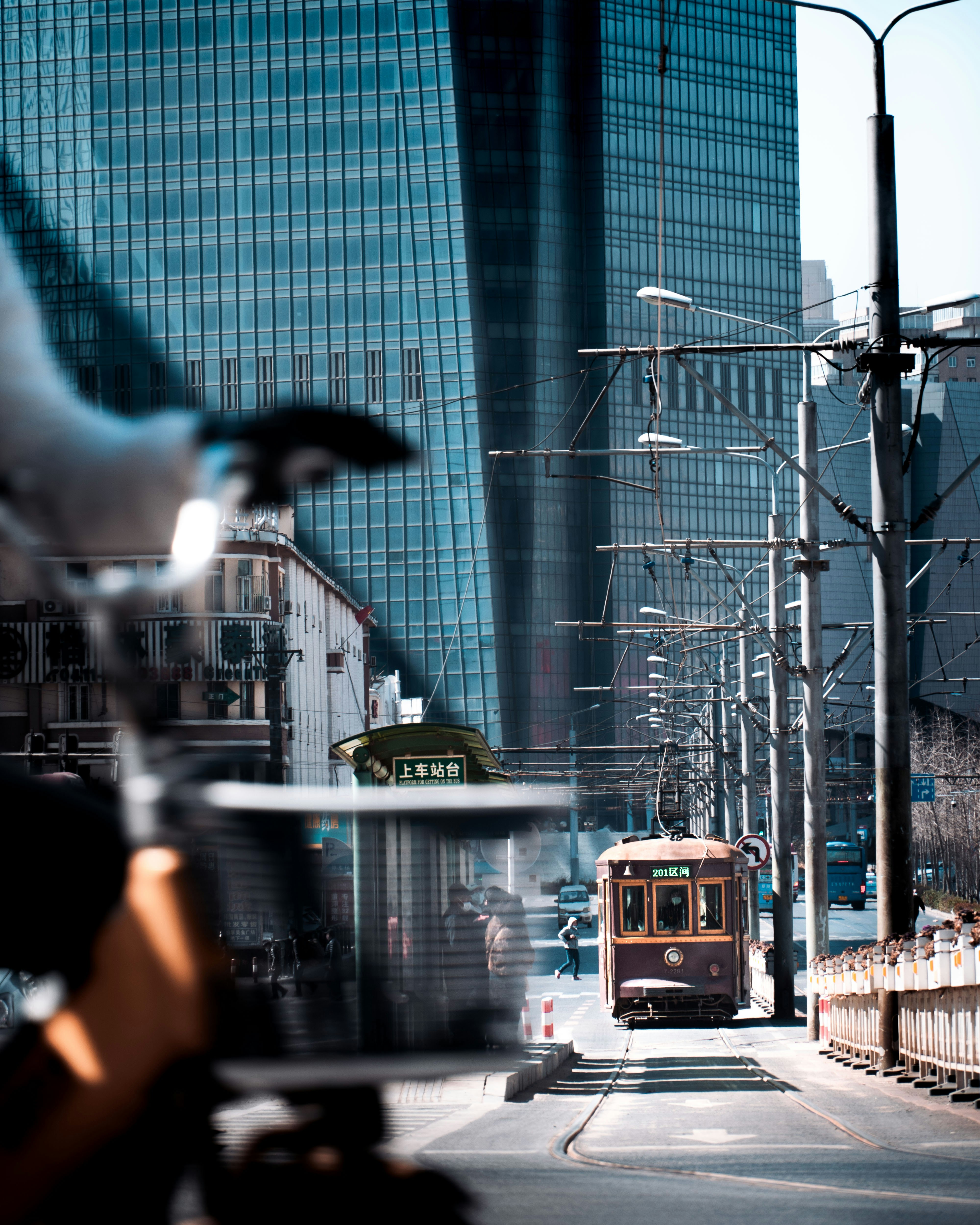 a bus is driving down the street in front of tall buildings