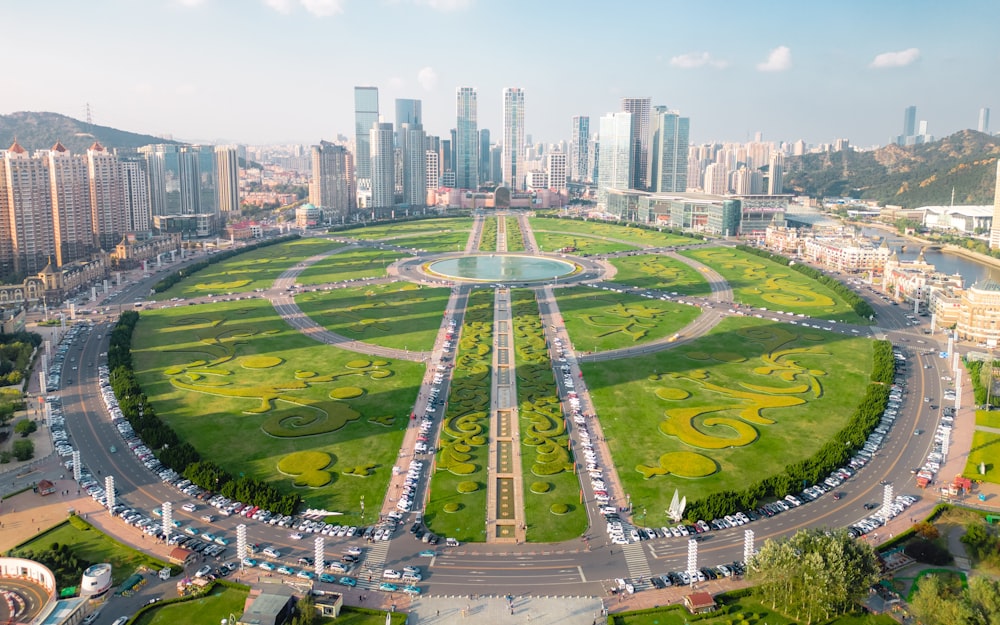 an aerial view of a city with lots of green grass