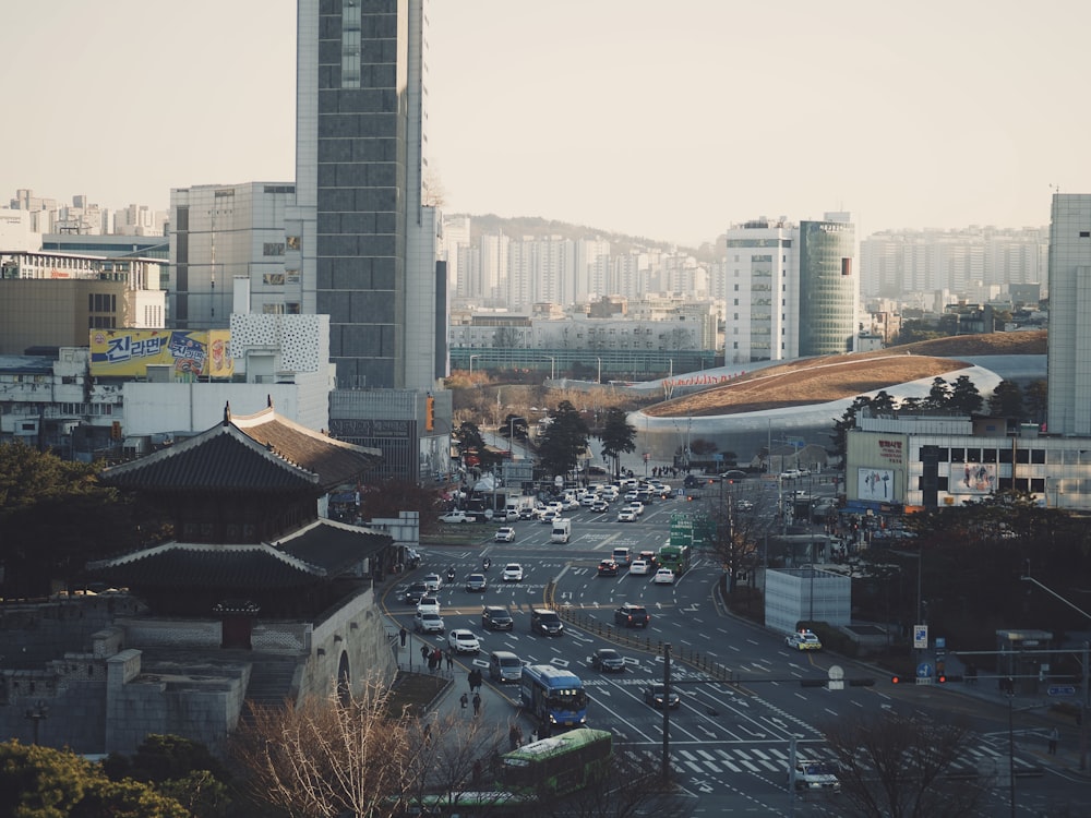 a busy city street with tall buildings in the background