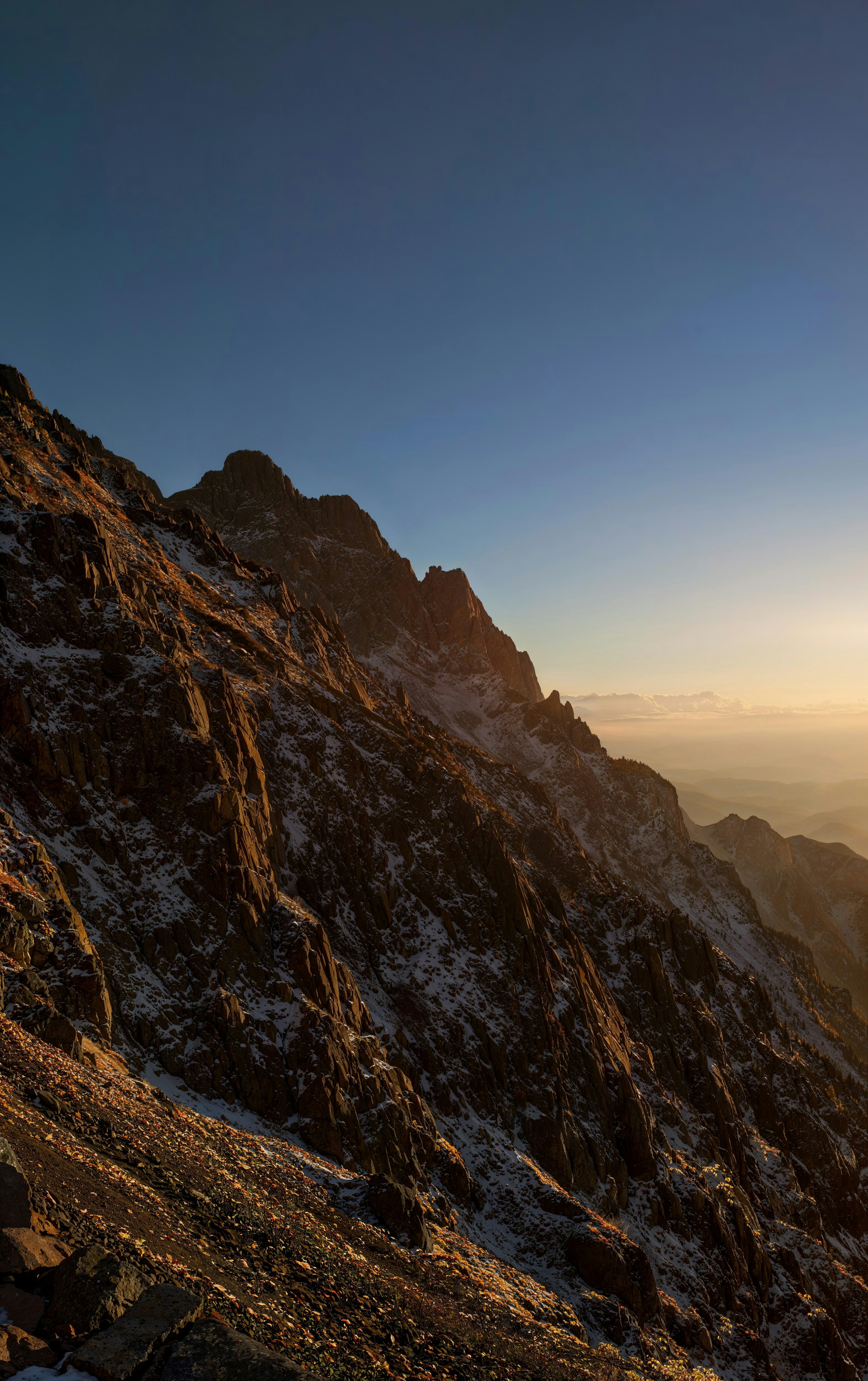 a person sitting on top of a snow covered mountain