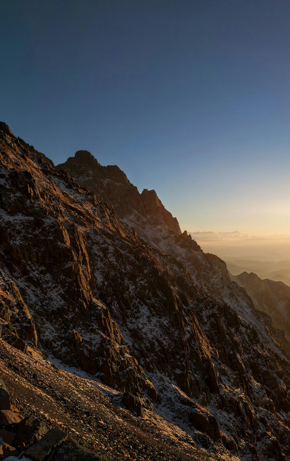 a person sitting on top of a snow covered mountain