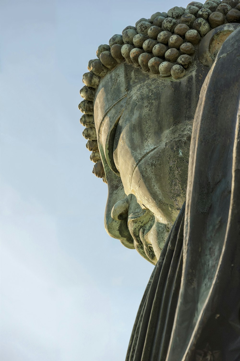 a close up of a statue with a sky background