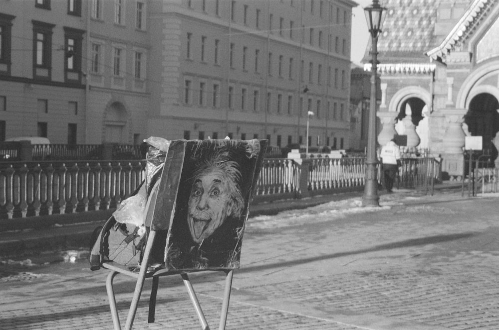 a black and white photo of a painting on a sidewalk