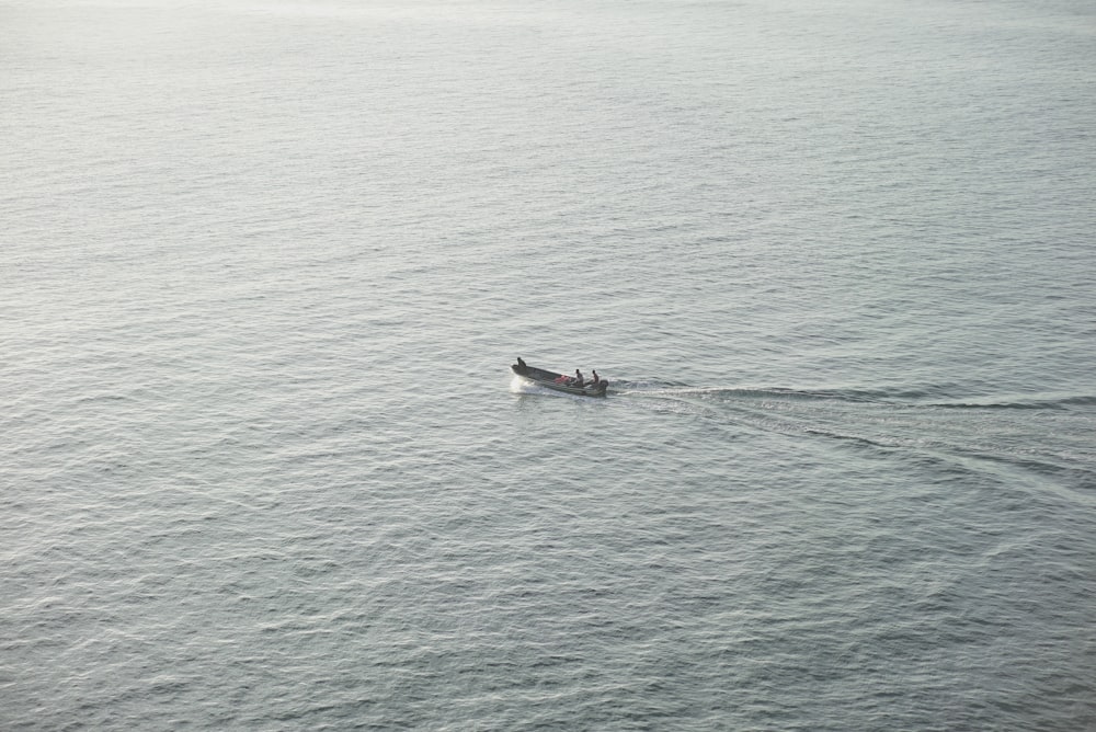 a person in a boat in the middle of the ocean