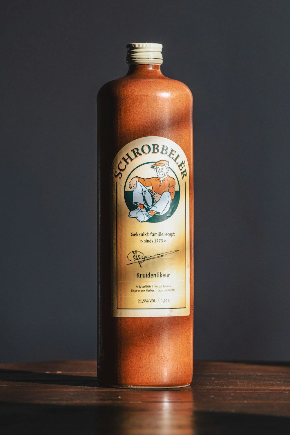 a bottle of hot sauce sitting on top of a wooden table