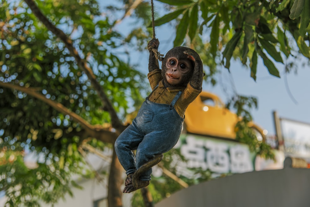 a statue of a monkey hanging from a tree
