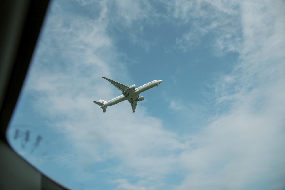 an airplane is flying in the sky with clouds