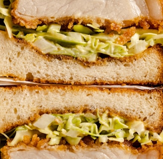 a close up of a sandwich with meat and lettuce