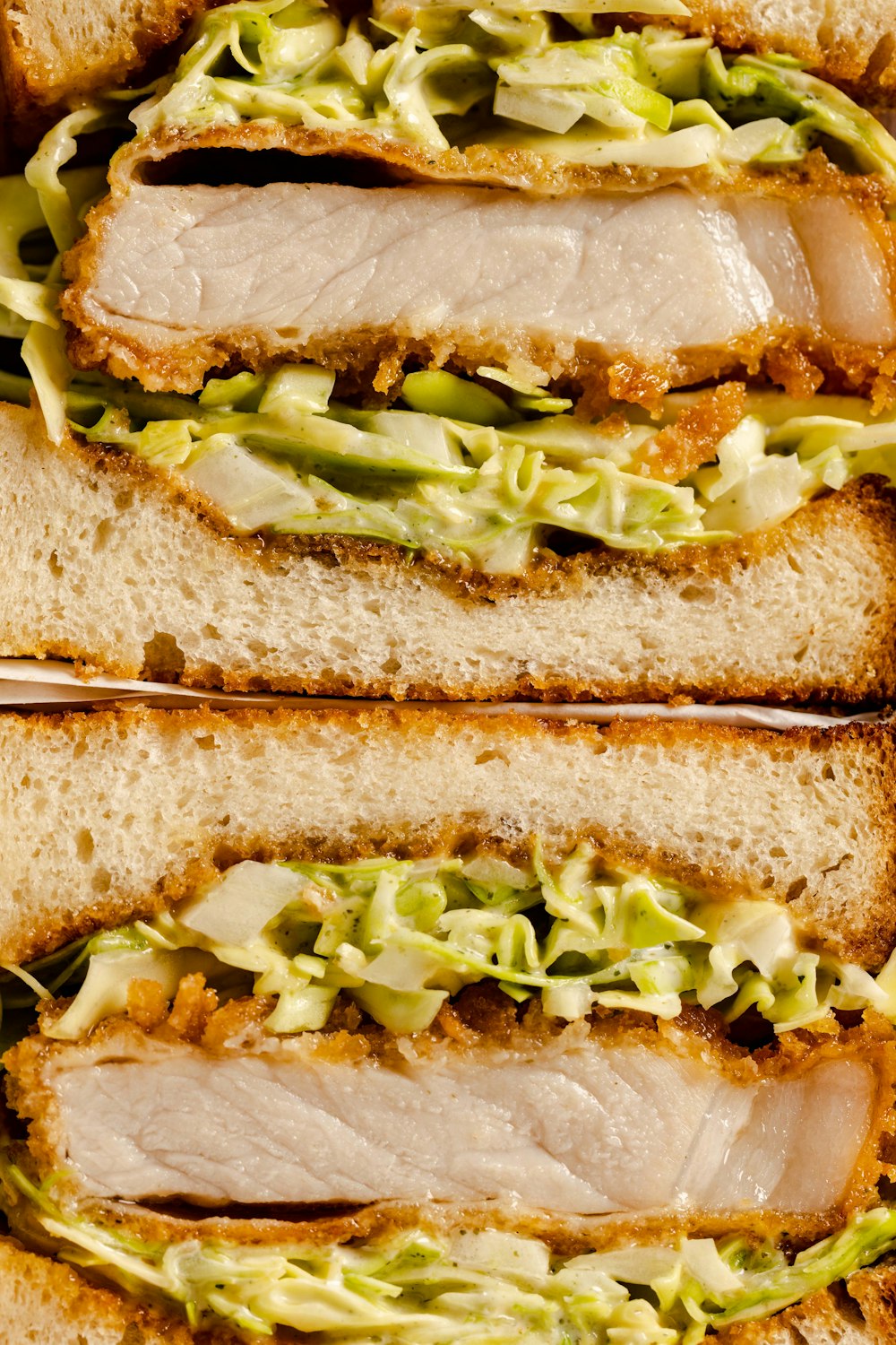 a close up of a sandwich with meat and lettuce