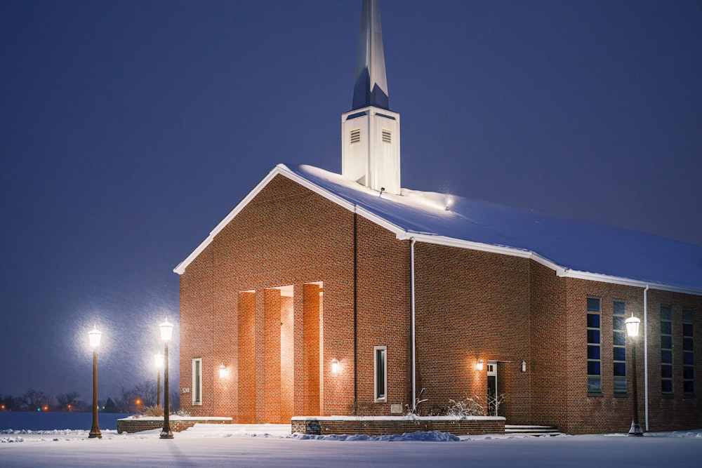 a church with a steeple lit up at night