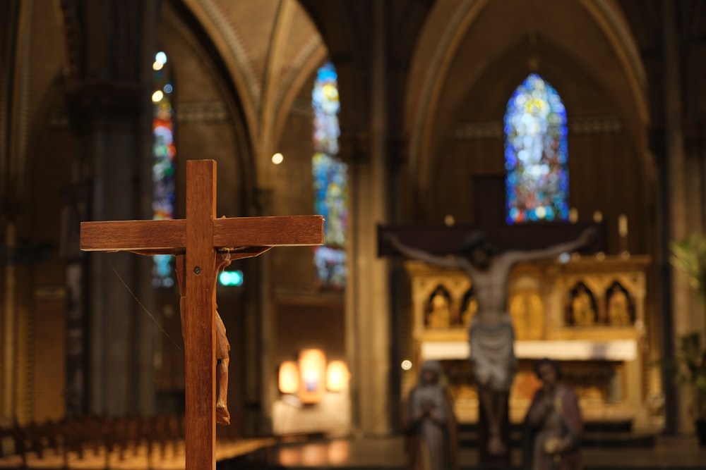 a crucifix in a church with stained glass windows